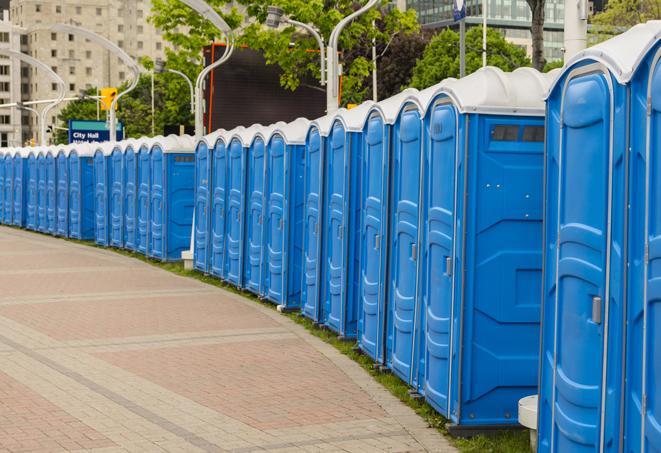 a fleet of portable restrooms ready for use at a large outdoor wedding or celebration in Ambler, PA